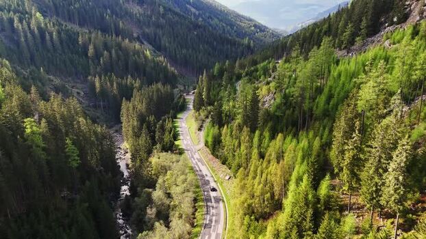 Aerial view of a winding road through a dense forest Austria. Aerial view of a winding road through a dense forest Austria.