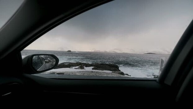 View of the choppy sea and snow capped mountains Norway.