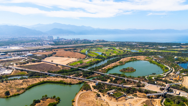 Aerial view of the Nuevo Vallarta area with its golf course waterways and the skyline of Puerto Vallarta in the distance Jalisco Mexico.