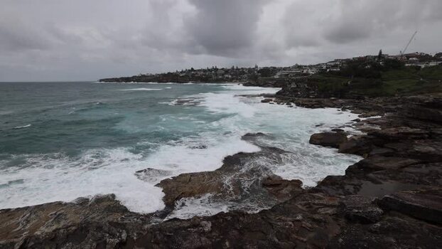 View of Bondi Beach coastline with crashing waves in Sydney Australia.