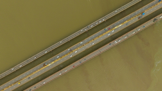 Aerial view of the Atal Setu bridge spanning the Mandovi River with traffic flowing across multiple lanes in Panaji Goa India.