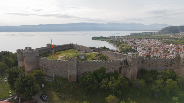 Aerial view of Samuel s Fortress overlooking Lake Ohrid with the town of Ohrid in the background surrounded by lush trees and mountains in Ohrid Municipality of Ohrid North Macedonia. Aerial view of Samuel s Fortress overlooking Lake Ohrid with the town of Ohrid in the background surrounded by lush trees and mountains in Ohrid Municipality of Ohrid North Macedonia.
