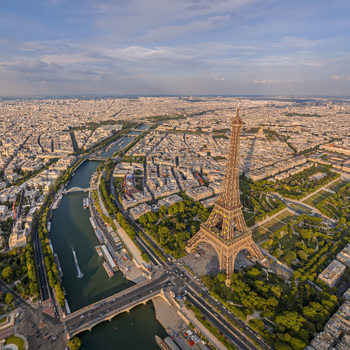 FRANCE. PARIS 75. AERIAL VIEW OF THE EIFFEL TOWER DISPLAYING THE EUROPEAN FLAG STARS WITH THE CHAMP DE MARS AND ECOLE MILITAIRE IN THE BACKGROUND.