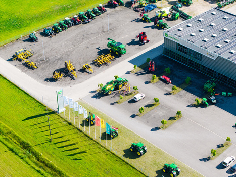Kekava Latvia 05 July 2026 Aerial view of an agricultural machinery dealership with rows of tractors harvesters a modern facility with solar panels and flags. Kekava Latvia 05 July 2026 Aerial view of an agricultural machinery dealership with rows of tractors harvesters a modern facility with solar panels and flags.