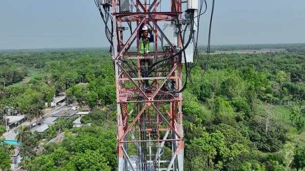 Aerial view of a technician working on a cell tower Bangladesh.