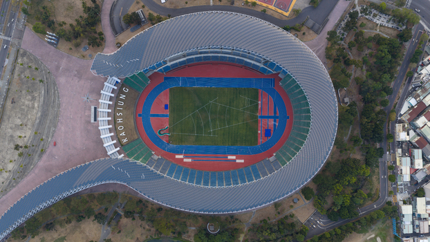 Aerial view of the Kaohsiung National Stadium featuring its unique solar powered roof and athletic track in Juguang Village Kaohsiung City Taiwan.
