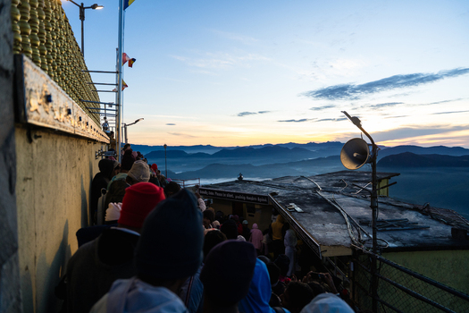 View of crowds gathered at Adam s Peak during sunrise with misty mountain ranges and a clear morning sky in the background Ratnapura Sabaragamuwa Province Sri Lanka. View of crowds gathered at Adam s Peak during sunrise with misty mountain ranges and a clear morning sky in the background Ratnapura Sabaragamuwa Province Sri Lanka.