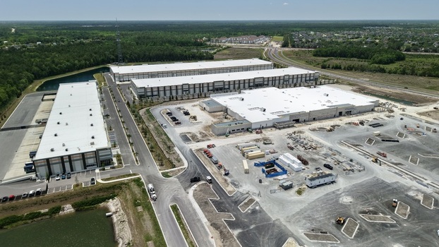 Aerial view of large industrial warehouses and construction site at Saint Johns Parkway and International Golf Parkway in World Golf Village Florida United States. Aerial view of large industrial warehouses and construction site at Saint Johns Parkway and International Golf Parkway in World Golf Village Florida United States.