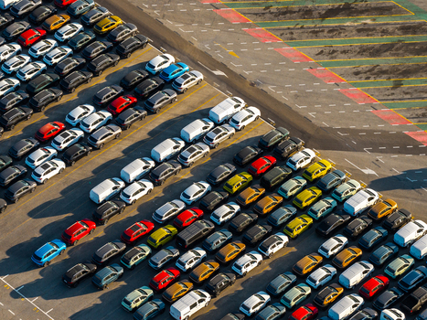 Aerial view of rows of new cars parked in the automotive terminal at the port of Civitavecchia Lazio Italy. Aerial view of rows of new cars parked in the automotive terminal at the port of Civitavecchia Lazio Italy.