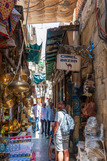 Cairo Egypt 20 April 2026 View of Khan el Khalili bazaar with traditional brass lamps a Camel Bazar sign and people walking through the narrow alleyway under fabric awnings. Cairo Egypt 20 April 2026 View of Khan el Khalili bazaar with traditional brass lamps a Camel Bazar sign and people walking through the narrow alleyway under fabric awnings.
