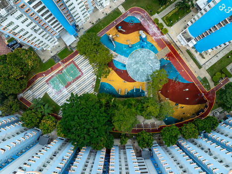 Aerial view of Boon Keng playground featuring a circular water feature and colorful ground patterns surrounded by trees and HDB apartment blocks in Singapore Bendemeer Road Singapore. Aerial view of Boon Keng playground featuring a circular water feature and colorful ground patterns surrounded by trees and HDB apartment blocks in Singapore Bendemeer Road Singapore.