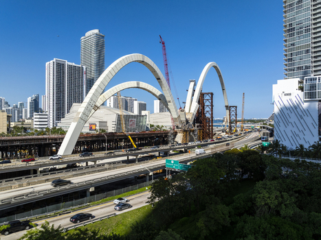 Aerial view of the vibrant cityscape where the new Signature Bridge s gleaming white arches contrast against the towering skyscrapers Miami Florida USA. Aerial view of the vibrant cityscape where the new Signature Bridge s gleaming white arches contrast against the towering skyscrapers Miami Florida USA.
