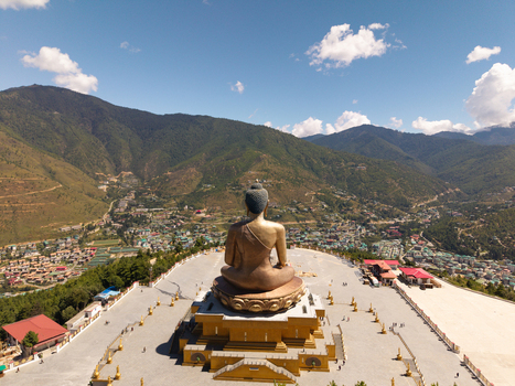 Aerial view of the Great Buddha Dordenma statue a beacon of serenity against the backdrop of rolling mountains stands majestically Thimphu Bhutan.