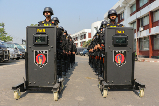 Dhaka Bangladesh 08 January 2017 View of Rapid Action Battalion officers standing in formation behind mobile ballistic shields at the RAB Headquarters. Dhaka Bangladesh 08 January 2017 View of Rapid Action Battalion officers standing in formation behind mobile ballistic shields at the RAB Headquarters.