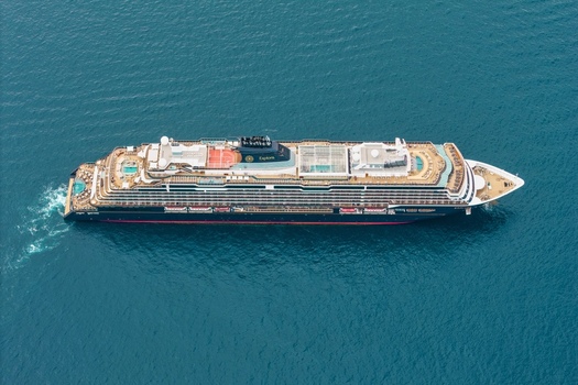 Aerial view of a large luxury cruise ship sailing on the deep blue Mediterranean Sea near the coast of Cannes Provence Alpes Cote d Azur France. Aerial view of a large luxury cruise ship sailing on the deep blue Mediterranean Sea near the coast of Cannes Provence Alpes Cote d Azur France.