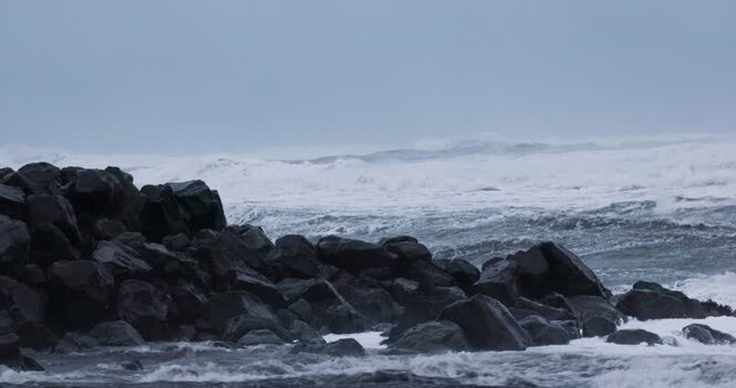 View of rough waves crashing against volcanic rocks Iceland. View of rough waves crashing against volcanic rocks Iceland.