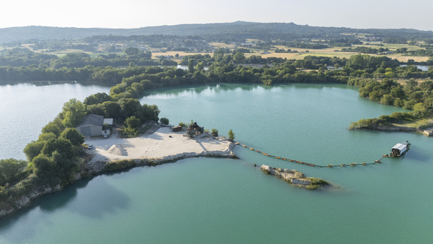Aerial view of the Extraccion de aridos Lima S.L sand extraction site with industrial machinery and a turquoise lake in Vilarino das Poldras Ourense Spain. Aerial view of the Extraccion de aridos Lima S.L sand extraction site with industrial machinery and a turquoise lake in Vilarino das Poldras Ourense Spain.