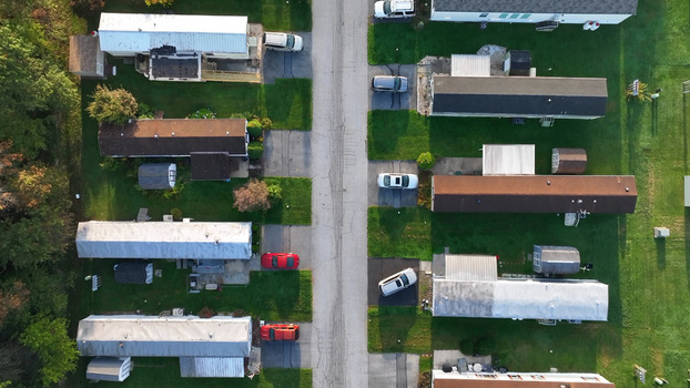 Aerial view of the Manheim housing development featuring rows of mobile homes paved driveways with parked cars and green lawns in Manheim Pennsylvania United States. Aerial view of the Manheim housing development featuring rows of mobile homes paved driveways with parked cars and green lawns in Manheim Pennsylvania United States.