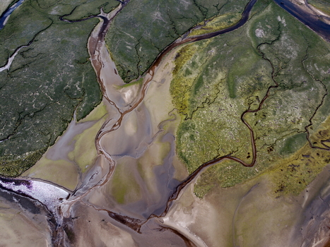 Aerial view of Findhorn Bay with winding water channels sandbanks and green marshland in Findhorn Scotland United Kingdom. Aerial view of Findhorn Bay with winding water channels sandbanks and green marshland in Findhorn Scotland United Kingdom.