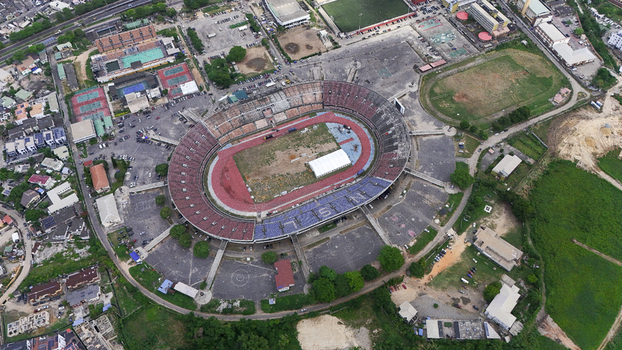 Aerial view of the National Stadium Surulere Lagos with its oval seating red running track and surrounding urban sports complex in Lagos Lagos Nigeria. Aerial view of the National Stadium Surulere Lagos with its oval seating red running track and surrounding urban sports complex in Lagos Lagos Nigeria.