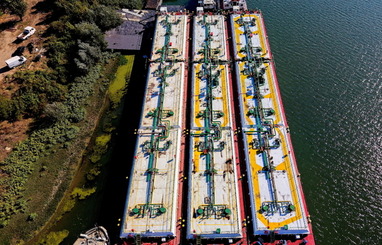 Aerial view of three large industrial barges moored at the Smederevo shipyard with complex piping systems on deck situated along the riverbank in Smederevo Podunavlje District Serbia. Aerial view of three large industrial barges moored at the Smederevo shipyard with complex piping systems on deck situated along the riverbank in Smederevo Podunavlje District Serbia.