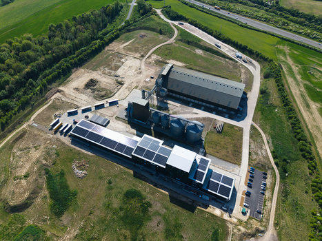 Aerial view of the Oat Milling Factory with industrial silos solar panels on rooftops and large warehouses surrounded by green fields in Kettering England United Kingdom. Aerial view of the Oat Milling Factory with industrial silos solar panels on rooftops and large warehouses surrounded by green fields in Kettering England United Kingdom.