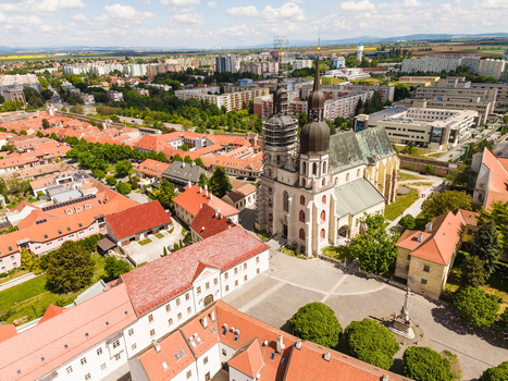 Aerial view of St. Nicholas Basilica with its iconic twin towers and red rooftops in the historic old town of Trnava Trnava Region Slovakia. Aerial view of St. Nicholas Basilica with its iconic twin towers and red rooftops in the historic old town of Trnava Trnava Region Slovakia.