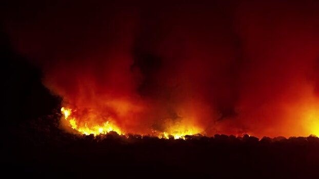 View of a wildfire burning at night in Spain.