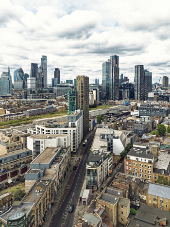 Aerial view of Shoreditch with its mix of modern skyscrapers and historic urban architecture under a cloudy sky in London England United Kingdom. Aerial view of Shoreditch with its mix of modern skyscrapers and historic urban architecture under a cloudy sky in London England United Kingdom.