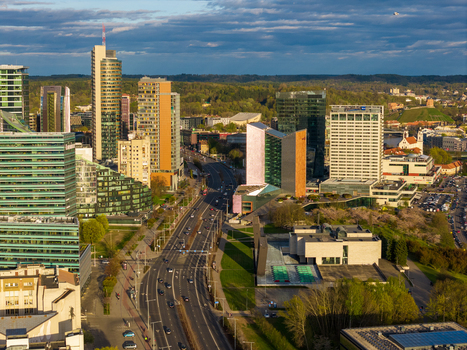Vilnius County Lithuania 01 May 2026 Aerial view of the modern business district in Vilnius with glass skyscrapers a wide avenue and lush green trees under a cloudy sky. Vilnius County Lithuania 01 May 2026 Aerial view of the modern business district in Vilnius with glass skyscrapers a wide avenue and lush green trees under a cloudy sky.
