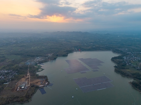 Aerial view of Sutami Dam at Karangkates with floating solar panel arrays on the reservoir surface surrounded by hills at sunset in Kecamatan Sumberpucung Jawa Timur Indonesia. Aerial view of Sutami Dam at Karangkates with floating solar panel arrays on the reservoir surface surrounded by hills at sunset in Kecamatan Sumberpucung Jawa Timur Indonesia.