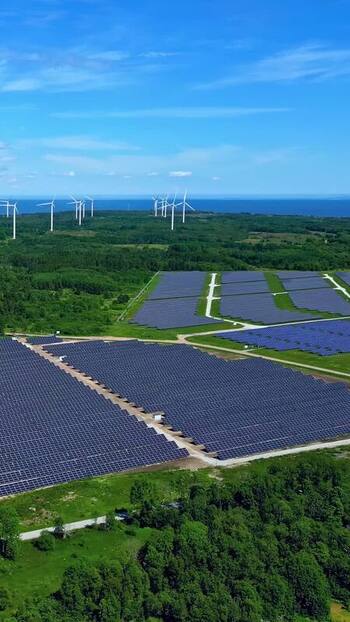 Aerial view of solar farm and wind turbines in Estonia. Aerial view of solar farm and wind turbines in Estonia.