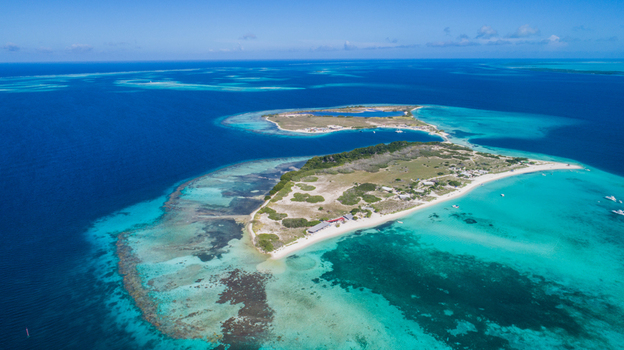 Aerial view of Los Roques archipelago featuring turquoise waters coral reefs and sandy beaches in Los Roques Dependencias Federales Venezuela. Aerial view of Los Roques archipelago featuring turquoise waters coral reefs and sandy beaches in Los Roques Dependencias Federales Venezuela.