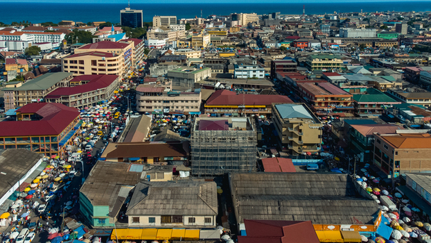 Accra Ghana 26 May 2023 Aerial view of the dense urban landscape of Makola Market with bustling streets colorful market stalls and surrounding commercial buildings. Accra Ghana 26 May 2023 Aerial view of the dense urban landscape of Makola Market with bustling streets colorful market stalls and surrounding commercial buildings.