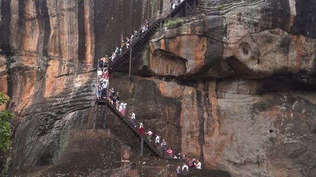View of tourists climbing the stairs at Sigiriya Rock Sri Lanka.