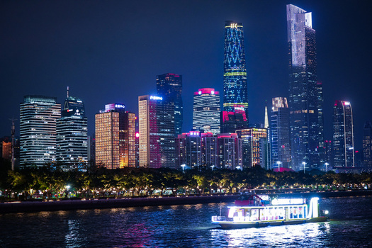 Guangzhou China 22 February 2024 View of the illuminated Guangzhou skyline and the Pearl River at night with a passenger boat. Guangzhou China 22 February 2024 View of the illuminated Guangzhou skyline and the Pearl River at night with a passenger boat.