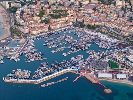 Aerial view of the Vieux Port in Cannes filled with luxury yachts and sailboats surrounded by the historic cityscape and coastal architecture of Cannes Provence Alpes Cote d Azur France. Aerial view of the Vieux Port in Cannes filled with luxury yachts and sailboats surrounded by the historic cityscape and coastal architecture of Cannes Provence Alpes Cote d Azur France.