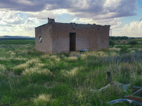 View of a weathered brick building standing in a grassy field under a cloudy sky in Grootdrink Northern Cape South Africa. View of a weathered brick building standing in a grassy field under a cloudy sky in Grootdrink Northern Cape South Africa.