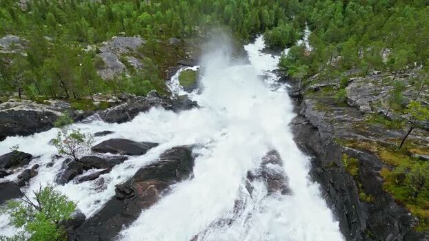 Aerial view of Kjemafossen waterfall rushing over rocks Norway.