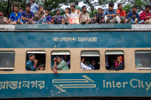Dhaka Bangladesh 14 June 2018 View of passengers crowded on the roof and looking out the windows of an intercity train at Airport Railway Station. Dhaka Bangladesh 14 June 2018 View of passengers crowded on the roof and looking out the windows of an intercity train at Airport Railway Station.