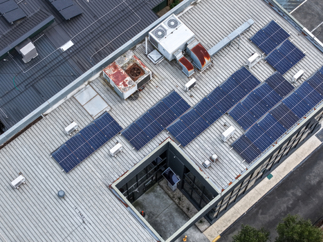 Melbourne Australia 25 September 2026 Aerial view of a rooftop featuring solar panels and HVAC units on an industrial building.