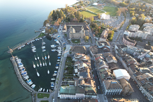 Aerial view of Morges Castle and the harbor with sailboats docked in the marina along the shores of Lake Geneva Morges Vaud Switzerland. Aerial view of Morges Castle and the harbor with sailboats docked in the marina along the shores of Lake Geneva Morges Vaud Switzerland.
