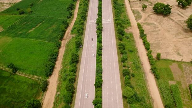 Aerial view of a highway passing through rural fields in India. Aerial view of a highway passing through rural fields in India.