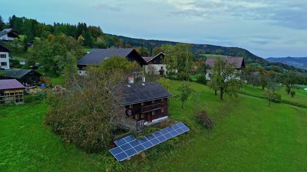 Aerial view of farmhouse with solar panels near Attersee Austria.