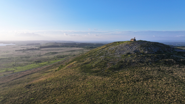 Aerial view of Chapelle Saint Michel de Brasparts on a rocky hilltop overlooking the vast moorland of the Monts d Arree Saint Rivoal Bretagne France. Aerial view of Chapelle Saint Michel de Brasparts on a rocky hilltop overlooking the vast moorland of the Monts d Arree Saint Rivoal Bretagne France.