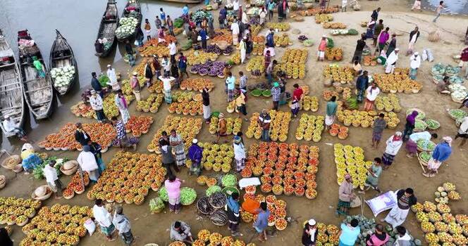 Aerial view of a bustling riverside vegetable market Bangladesh.