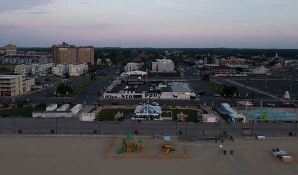 Aerial view of Asbury Park Beach with the Stone Pony boardwalk playground and urban architecture under a soft evening sky in Asbury Park New Jersey United States.