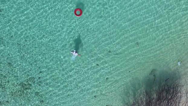 Aerial view of a person in turquoise water Maldives.