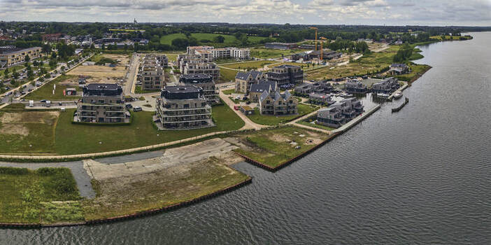 Schleswig Schleswig Holstein Germany 01 July 2026 Aerial view of the Quartier Schlei Leben redevelopment with modern apartments and water houses on former military base grounds.