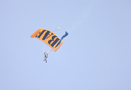 Dhaka Bangladesh 25 March 2026 View of a skydiver descending gracefully through the expansive azure sky with a vibrant parachute.